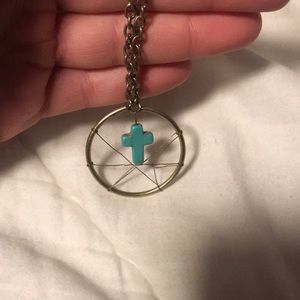 Oversized gold necklace with teal cross